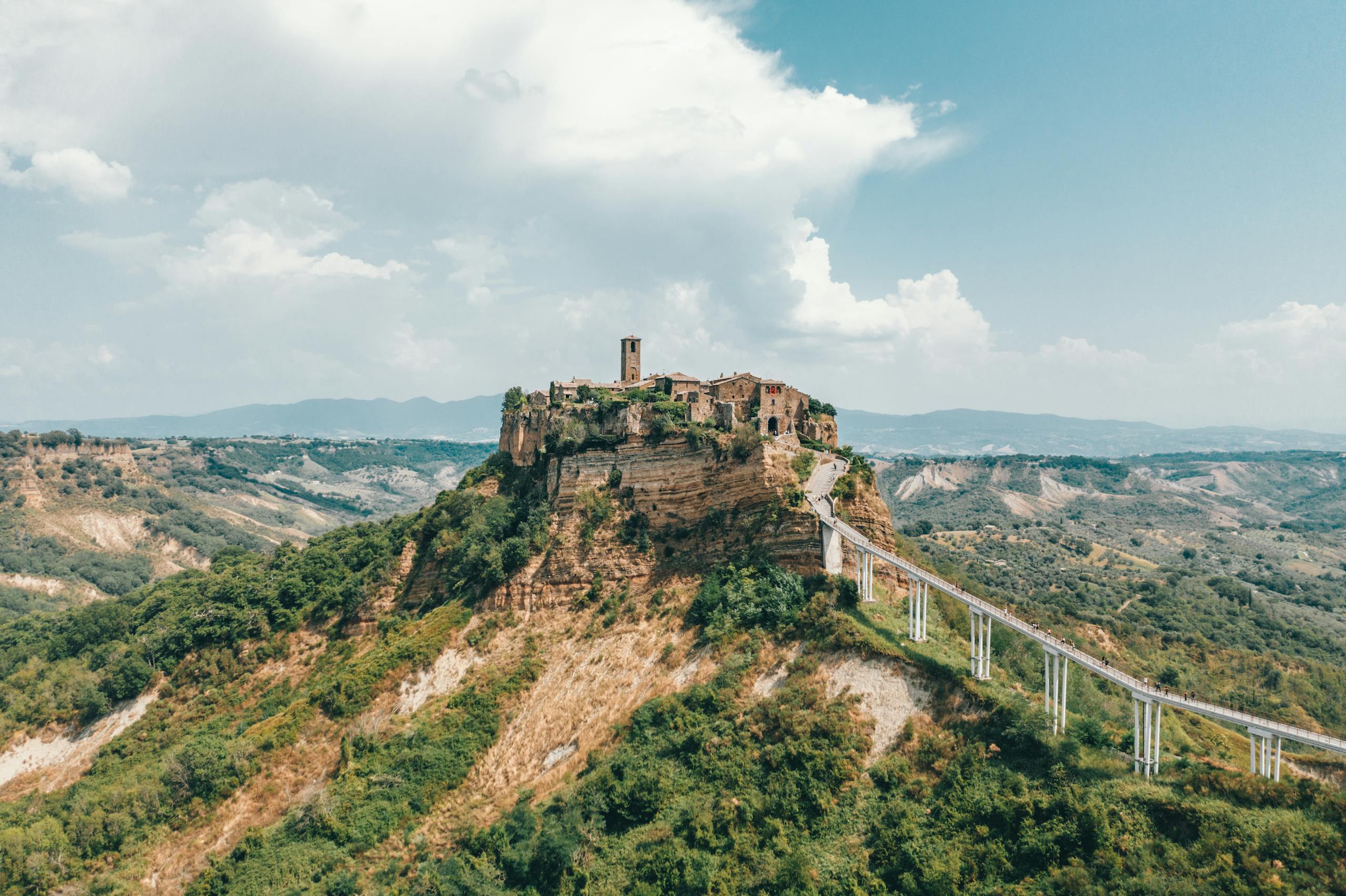 Discover the breathtaking Civita di Bagnoregio, a captivating hilltop town in Italy surrounded by dramatic landscape.